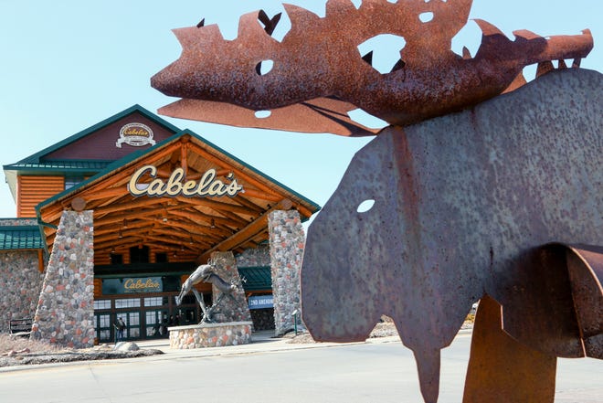 FILE - In this Wednesday, Feb. 17, 2016, file photo, statues of wildlife adorn the entrance to a Cabela's store in LaVista, Neb. Outdoor gear giants Bass Pro and Cabela's will combine in a $4.5 billion deal announced Monday, Oct. 3, 2016. (AP Photo/Nati Harnik, File)