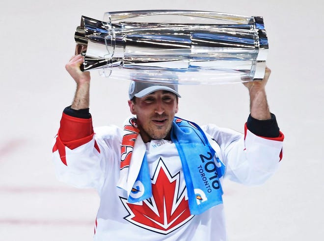 Canada's Brad Marchand of the Boston Bruins hoists the trophy following his team's 2-1 victory over Europe during Game 2 of the World Cup of Hockey finals, in Toronto on Thursday, Sept. 29, 2016. Canada won the championship 2-0.