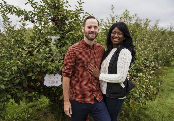 Kyle Vowell and Sierra Harlan of Chicago, shown here on Sunday, Oct. 2, 2016, are the first couple to be engaged at Curran's Orchard in Rockford. "She loves fall, and has always wanted to go to an apple orchard, so I've kind of kept that in my back pocket for over a year now," Vowell said. He proposed after attaching a ribbon and ring (background) to a tree branch. KAYLI PLOTNER/STAFF PHOTOGRAPHER/RRSTAR.COM