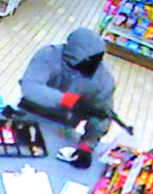 Falls police are looking for a masked, armed suspect in the overnight robbery of the 7-Eleven on Alden Avenue.