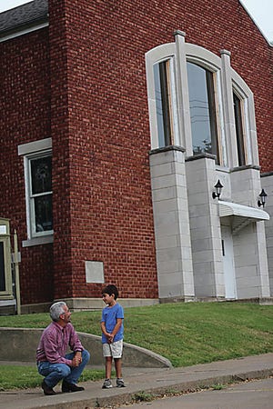The Ray of Hope Advocacy Center is raising money to renovate the former Grace Epworth United Methodist Church building into its new offices. Community Chair Bob Fraser and Children's Chair Jack Ihrig stand in front of the church. Submitted