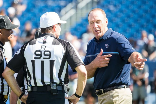 Tennessee Titans head coach Mike Mularkey speaks with officials during a game.