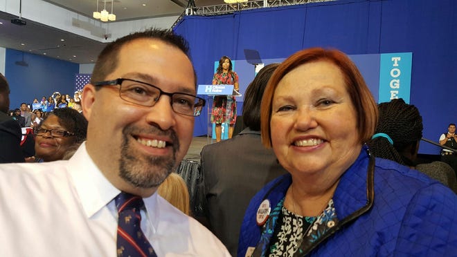 Gastonia City Councilman Robert Kellogg takes a selfie with Kings Mountain resident Betsy Wells, chairwoman of the 10th U.S. House Democratic Party, while first lady Michelle Obama delivers a speech in Charlotte on Tuesday.