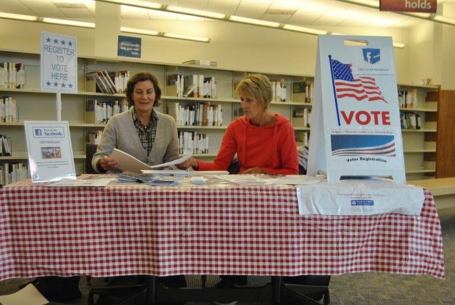 The local League of Women Voters set up a table in the Herrick District Library on Saturday, Oct. 1, as part of its voter-registration drive. Austin Metz/Sentinel staff