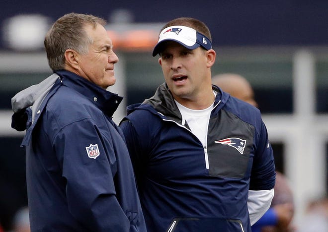 Josh McDaniels, right, talks with Bill Belichick before Sunday's game.
