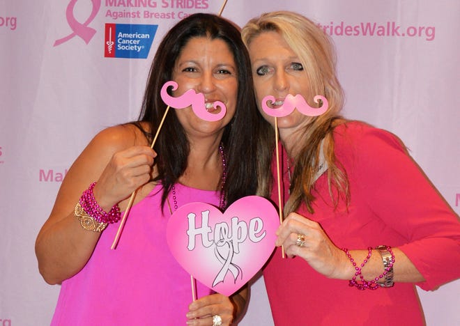 Jackie Savigne and Missy Weishaar celebrate at the Making Strides Against Breast Cancer of Sarasota-Manatee Kick-off Reception in August. WENDY DEWHURST CLARK/HERALD-TRIBUNE PHOTO