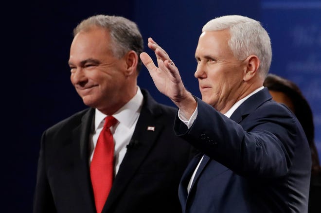 Republican vice-presidential nominee Gov. Mike Pence, right, arrives with Democratic vice-presidential nominee Sen. Tim Kaine during the vice-presidential debate at Longwood University in Farmville, Va., Tuesday, Oct. 4, 2016. (AP Photo/Julio Cortez)