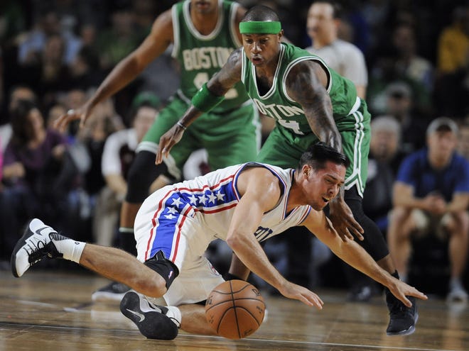 Celtics guard Isaiah Thomas knocks the ball from Philadelphia 76ers' T.J. McConnell during a preseason game, Tuesday, at the Mullins Center in Amherst. The Associated Press