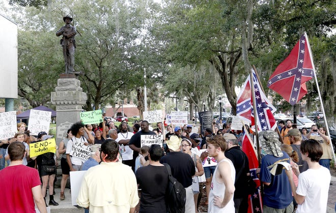 In this July 9, 2015 file photo, protesters speak and chant next to a Confederate statue at the Alachua County Administration building. (Gainesville Sun file photo)