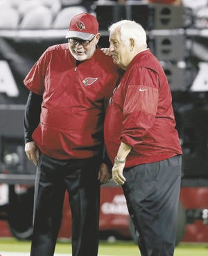 Arizona Cardinals head coach Bruce Arians talks with assistant head coach Tom Moore (right) prior to a preseason game against the Denver Broncos on Sept. 1, in Glendale, Ariz.