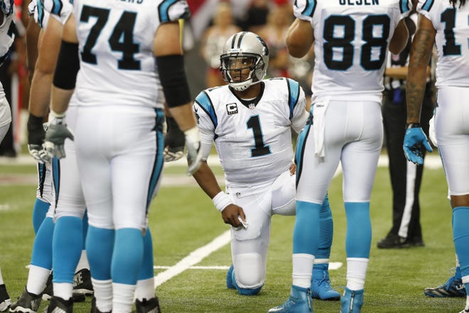 Carolina Panthers quarterback Cam Newton calls a play in the huddle against the Atlanta Falcons during the first half of Sunday's game in Atlanta. (AP Photo/John Bazemore)