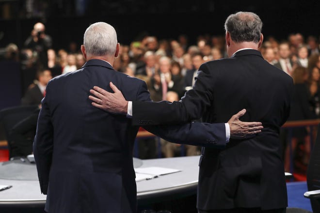 Republican vice-presidential nominee Gov. Mike Pence and Democratic vice-presidential nominee Sen. Tim Kaine stand after the vice-presidential debate at Longwood University in Farmville, Va., Tuesday, Oct. 4, 2016. (Joe Raedle/Pool via AP)