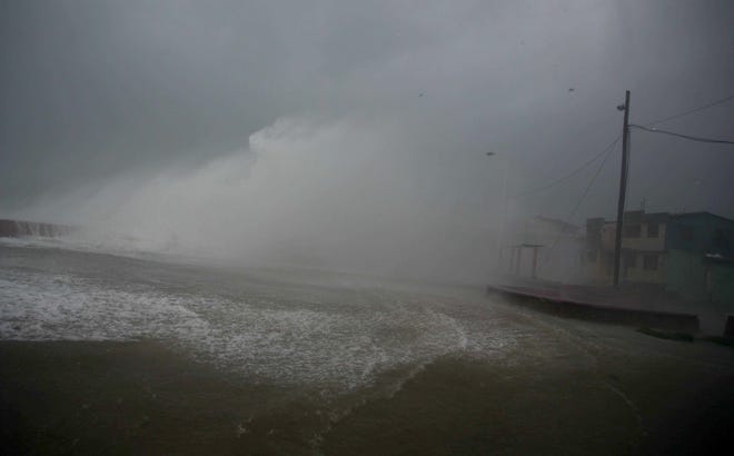 Surf and wind from Hurricane Matthew crash on the waterfront in Baracoa, Cuba, Tuesday, Oct. 4, 2016. The dangerous Category 4 storm blew ashore around dawn in Haiti. It unloaded heavy rain as it swirled on toward a lightly populated part of Cuba and the Bahamas. (AP Photo/Ramon Espinosa)