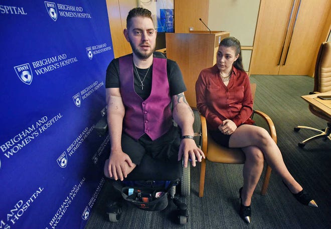 Retired Marine Sergeant John Peck speaks about his double arm transplant with his fiancée, Jessica Paker, Wednesday, Oct. 5, 2016 at Brigham and Women's Hospital in Boston. Peck, a former Marine sergeant who underwent a double arm transplant said Wednesday that the best part about having arms again is that he can hold his fiancee's hand and pursue his lifelong dream of becoming a chef. (Patrick Whittemore/The Boston Herald via AP)