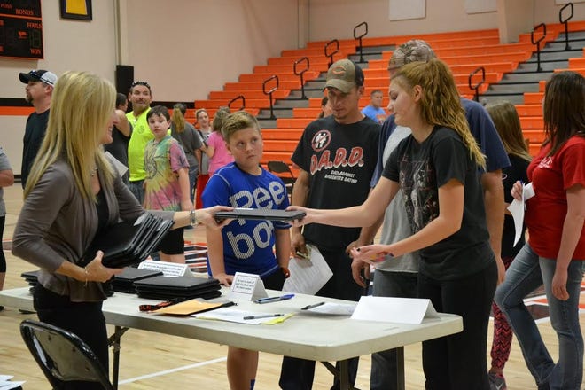 Joyce Jones, 6th grade teacher at LJHS, hands out Chromebooks to her students Wednesday in Lincoln. Photo submitted