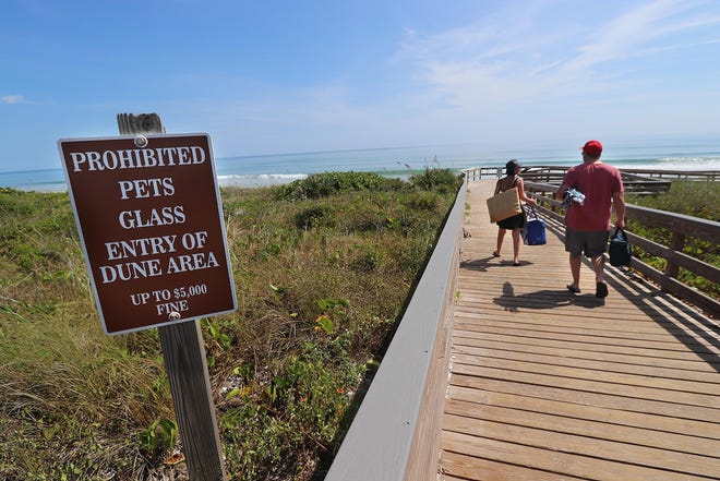 Visitors head for the beach at Canaveral National Seashore just south of New Smyrna Beach in this file photo. The superintendent at Canaveral National Seashore was abruptly reassigned by the National Park Service following a series of investigations into misconduct, improper purchasing practices and sexual misconduct by park employees. News-Journal/JIM TILLER.