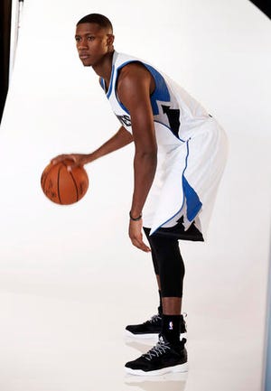 In this Sept. 26, 2016 photo, Minnesota Timberwolves Kris Dunn poses for the team photographer during the NBA basketball teams media day in Minneapolis. A ripe old 22 years of age, Dunn is older than four of the team's high-profile "veterans." The extra time in college has helped him transition to the NBA, and the fifth overall pick will make his debut in a preseason game on Saturday. (AP Photo/Jim Mone)