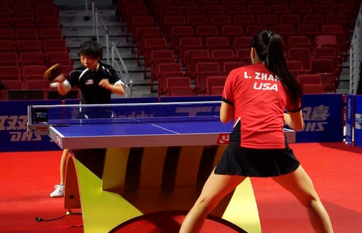 In this image from video, Yue Wu, of the United States, hits the ball during a practice match against countrywoman Lily Zhang, Thursday, Oct. 6, 2016, in Philadelphia. The Women's Table Tennis World Cup in Philadelphia this weekend is the first time the event is being held in the United States. (AP Photo/Dake Kang)