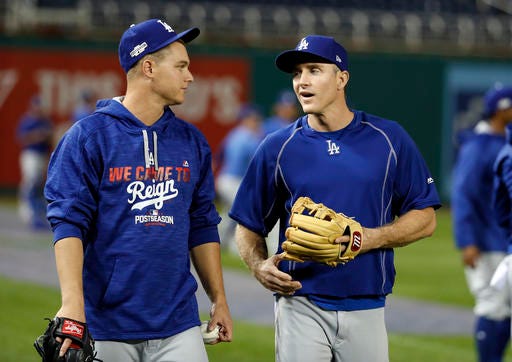 Los Angeles Dodgers center fielder Joc Pederson, left, and second baseman Chase Utley talk during baseball batting practice at Nationals Park, Wednesday, Oct. 5, 2016, in Washington. The Nationals host the Los Angeles Dodgers in Game 1 of the National League Division Series baseball game on Friday. (AP Photo/Alex Brandon)