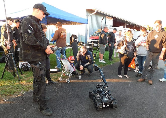 Herkimer Patrolman Don Richards, a member of the Special Response Team, operates a device that would be used in a dangerous scenario during the 2016 Mohawk Valley Regional Fire Prevention and Citizen Emergency Preparedness Expo on Wednesday. Several demonstrations were part of the event. TIMES TELEGRAM PHOTO/STEPHANIE SORRELL-WHITE