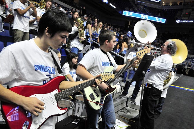Rogers High School students, under the direction of music teacher Donald ‘Doc’ Smith, right, perform during a University of Rhode Island men’s basketball game in January. Rogers students and students from Thompson Middle School served as the pep band during the game. Smith resigned this week.