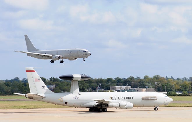 With an E-3 Sentry from the 552nd Air Control Wing waiting to take off Oct. 6, a Navy P-8 Poseidon comes in for a landing at Tinker Air Force Base, Oklahoma. Eight P-8s and three P-3 Orion aircraft from Naval Air Station Jacksonville, Florida, sheltered from Hurricane Matthew here. (Air Force photo by April McDonald)