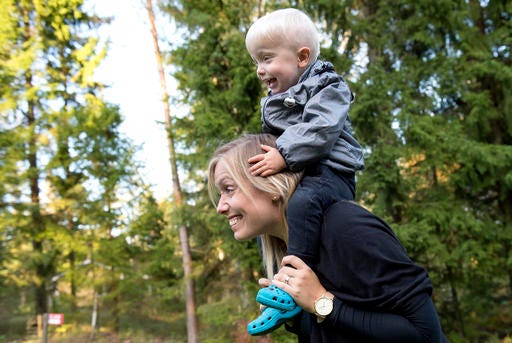 Emelie Eriksson carries her son Albin outside her home in Bergshamra, Sweden. Eriksson was the first woman to have a baby after receiving a womb transplant from her mother, a revolutionary operation that links three generations of their family.