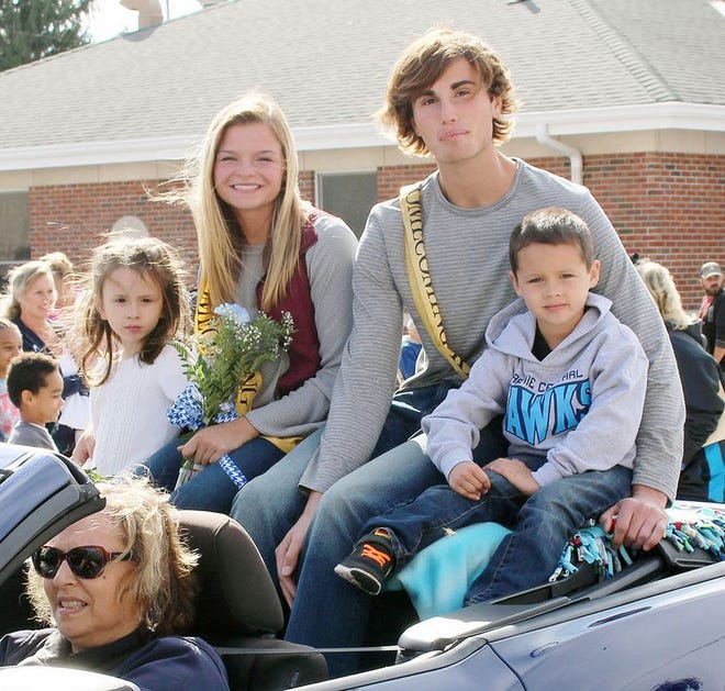 Homecoming queen and king Annaliese Miller and Tom Shafer ride with crown bearers in the Prairie Central Homecoming parade Friday.