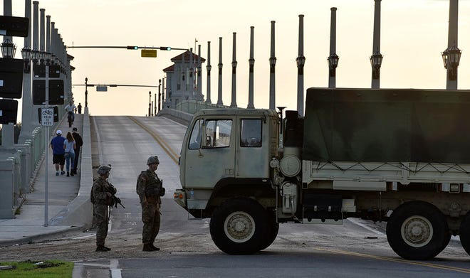 PETER.WILLOTT@STAUGUSTINE.COM The National Guard blocks access to Anastasia Island via the Bridge of Lions in St. Augustine on Saturday, October 8, 2016.