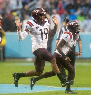 Virginia Tech's Chuck Clark (19) celebrates following a turnover against North Carolina during the first half of an NCAA college football game in Chapel Hill, N.C. Saturday, Oct. 8, 2016. (AP Photo/Ben McKeown)