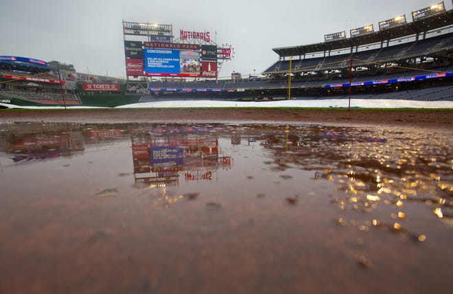A puddle forms in front of the entrance to the Los Angeles Dodgers' dugout at Nationals Park in Washington on Saturday. The Associated Press