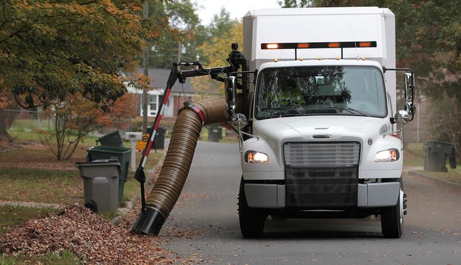 A Gastonia city leaf collection truck vacuums leaves along Trinity Avenue on Oct. 26, 2015. Mike Hensdill/The Gazette