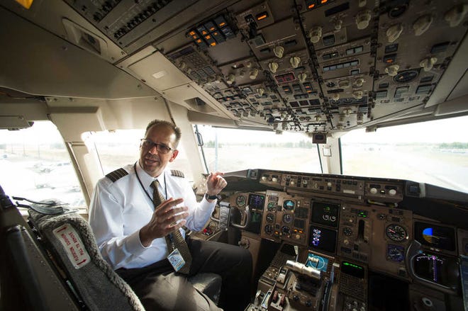 UPS Capt. Christian Kast talks about the Data Communications Data Comm technology from the cockpit of an UPS Boeing 767-300F aircraft at Dulles International Airport Air Traffic Control Tower in Sterling, Va., Tuesday, Sept. 27, 2016. Data Comm gives air traffic controllers and pilots the ability to transmit flight plans, clearances, instructions, advisories, flight crew requests, and reports via a digital message service. (AP Photo/Cliff Owen)
