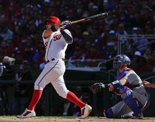 Nationals' Jose Lobaton, left, connects for a three-run home run off Dodgers' Rich Hill during the fourth inning. The Associated Press