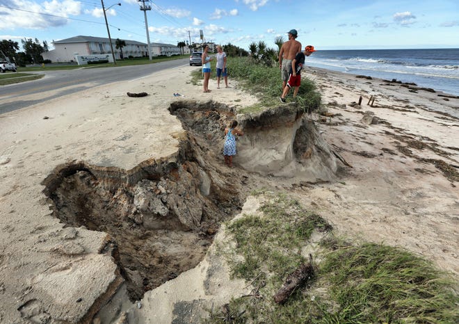 Residents check out the erosion caused by high surf from Hurricane Matthew along A-1-A, in Ormond-By-The-Sea, Fla., Saturday. Oct. 8, 2016. (Joe Burbank/Orlando Sentinel via AP)