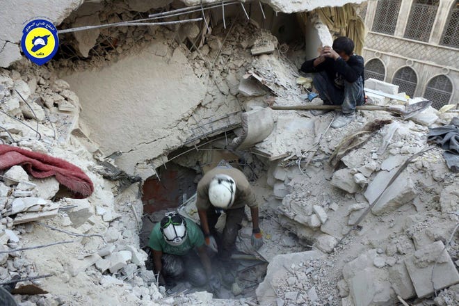 This Tuesday, Oct. 4, 2016 photo, provided by the Syrian Civil Defense group known as the White Helmets, shows Civil Defense workers from the White Helmets digging in the rubles to remove bodies and look for survivors, after airstrikes hit the Bustan al-Basha neighborhood in Aleppo, Syria. The implosion of diplomatic talks with Russia has left the Obama administration with a series of bad options for what to do next in Syria. Despite harrowing scenes of violence in Aleppo and beyond, President Barack Obama is unlikely to approve any risky new strategy before handing the civil war over to his successor early next year. (Syrian Civil Defense White Helmets via AP)