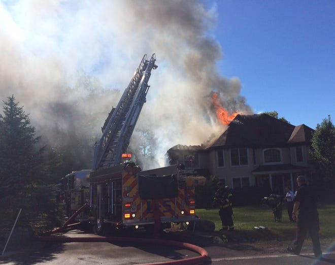 Smoke soars into the air from a house fire on Arbor Way in Stroud Township Monday. (Andrew Scott/Pocono Record)
