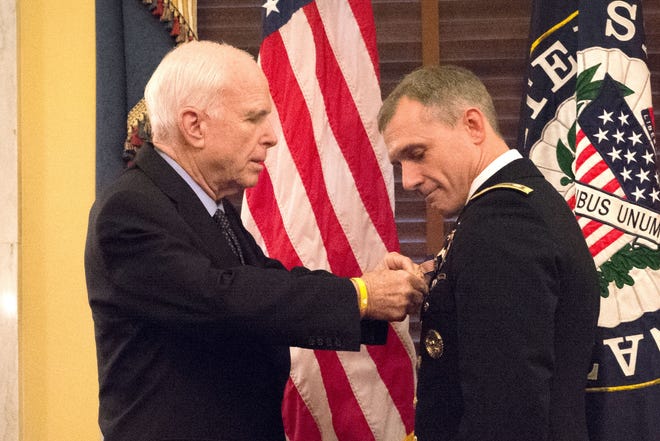 Sen. John McCain pins a Soldier's Medal on Lt. Col. David P. Diamond for saving lives at the Boston Marathon three years ago. The medal was presented during a ceremony on Capitol Hill, Sept. 27, 2016. U.S. Army photo​