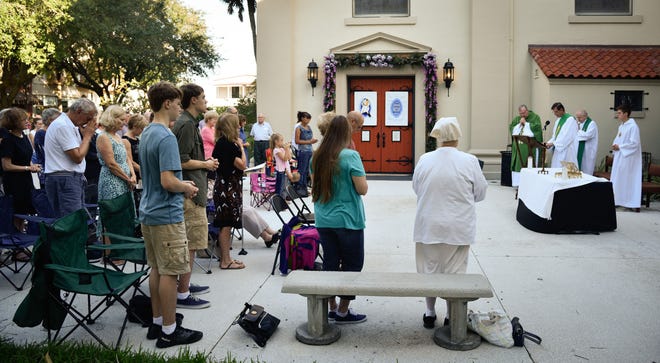 PETER.WILLOTT@STAUGUSTINE.COM 
Priests hold Mass in the courtyard of the Cathedral Basilica in St. Augustine on Sunday, October 09, 2016. The service could not be held in the church because of damage caused by Hurricane Matthew.