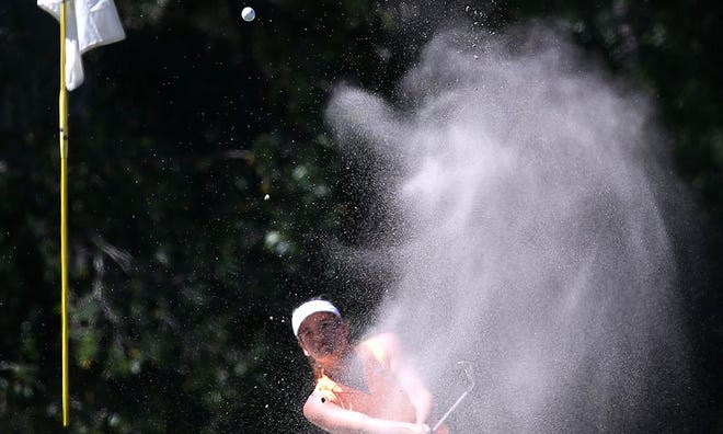 Mosley's Marybeth McGuire hits out of the bunker on the 12th hole at the Panama Country Club in Lynn Haven on Monday.