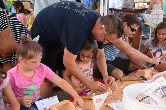 Chris and Zoe Brown build a tool box at the Home Depot station at the kids' fall festival Friday afternoon at AJ's. ANNIE BLANKS/The Destin Log