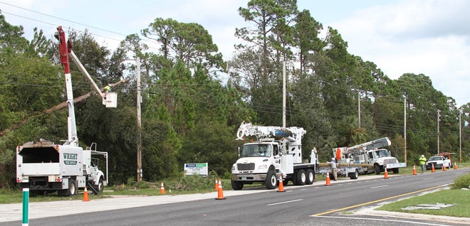 Florida Power & Light crews clear trees off lines along SR100 outside Flagler Beach, Saturday Octerber 8, 2017 following Hurricane Matthew's devastation.  News-Journal/David Tucker