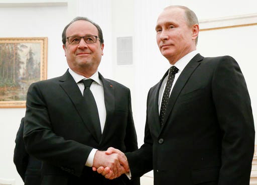 FILE- In this Thursday, Nov. 26, 2015 file photo, Russian President Vladimir Putin, right, shakes hands with his French counterpart Francois Hollande during their meeting in Moscow, Russia. Amid a bitter rift over Syria, Russian President Vladimir Putin indefinitely postponed a visit to France after Paris had revised its program and said it would talk about nothing else but the Syrian crisis. (AP Photo/Alexander Zemlianichenko, Pool, File)