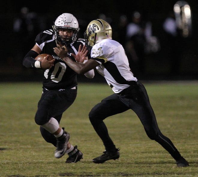 Forestview's Jaylen McCree looks to stiff arm a North Gaston defender Monday night. The Jaguars defeated the Wildcats 30-6 in a game rescheduled from last week due to incliment weather. (Brian Mayhew/Special to the Gazette)