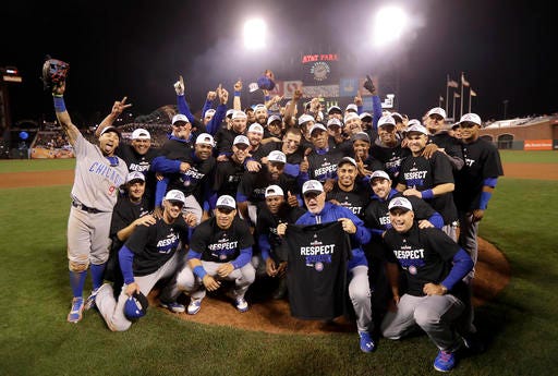 Chicago Cubs players and coaches celebrate after Game 4 of baseball's National League Division Series against the San Francisco Giants in San Francisco, Tuesday, Oct. 11, 2016. The Cubs won 6-5. (AP Photo/Marcio Jose Sanchez)
