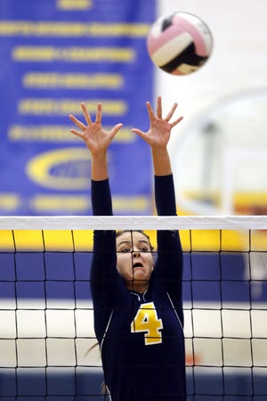 Notre Dame High School’s Johanna Myers attempts to block a spike during the Nikes’ match against Holy Trinity on Tuesday at Father Minett Gymnasium.