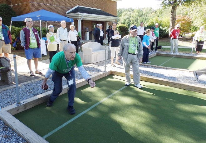 Dale Kreutter of Lanier Village Estates retirement community in Gainesville, Ga. takes a shot in the bocce ball event at OlympiActs on Tuesday at Tryon Estates.