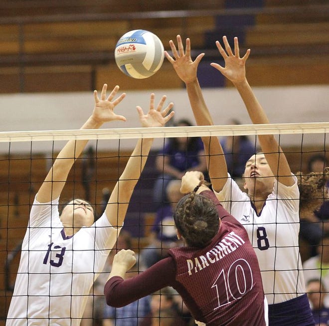 Bronson’s Jill Pyles (13) and Keona Salesman combine for a block against Parchment on Wednesday.
