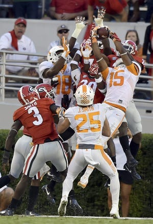 Tennessee wide receiver Jauan Jennings (15) leaps in front of Georgia defenders for the game-winning touchdown as time expires during their game in Athens, Ga., on Oct. 1. The Associated Press