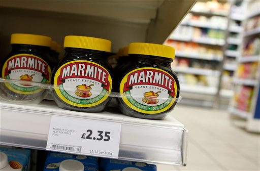 Jars of savoury spread 'Marmite' which is owned by the Anglo-Dutch multinational Unilever, on sale in a branch of Tesco in central London, Thursday, Oct. 13,2016. Britain's biggest supermarket chain, Tesco, has pulled cherished products such as Marmite spread and Ben & Jerry's ice cream from its website amid a dispute with consumer goods giant Unilever. (AP Photo/Alastair Grant)